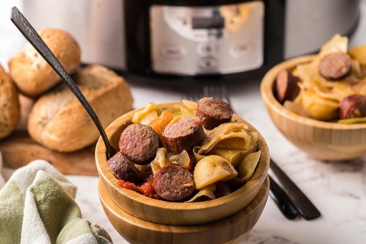 Slow cooker kielbasa with cabbage and potatoes in a bowl.