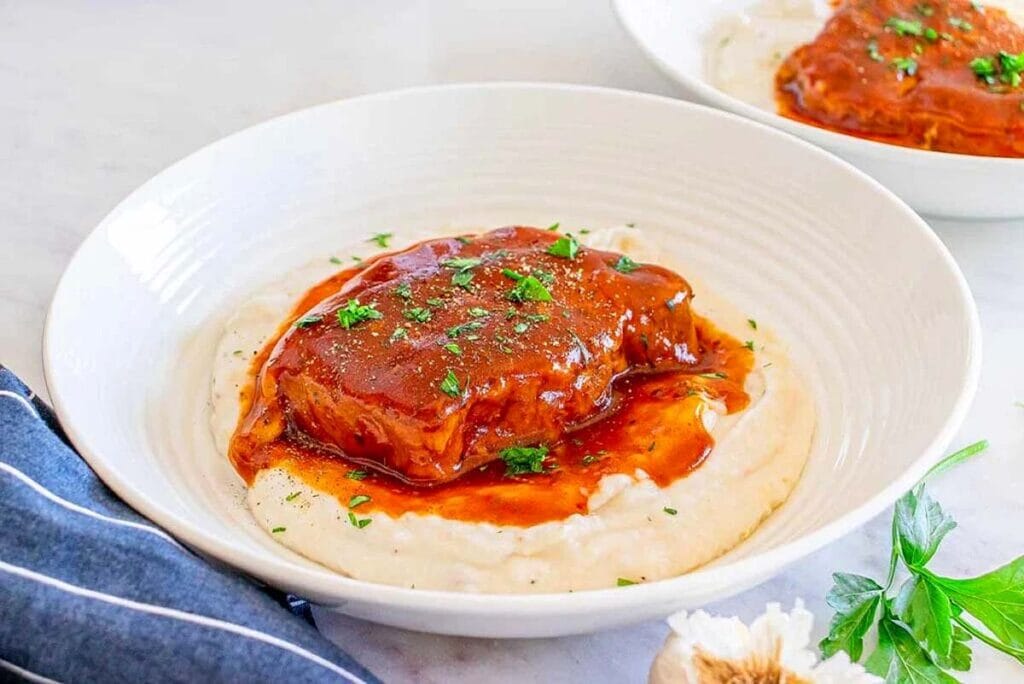 Pork chops served with mashed potatoes.