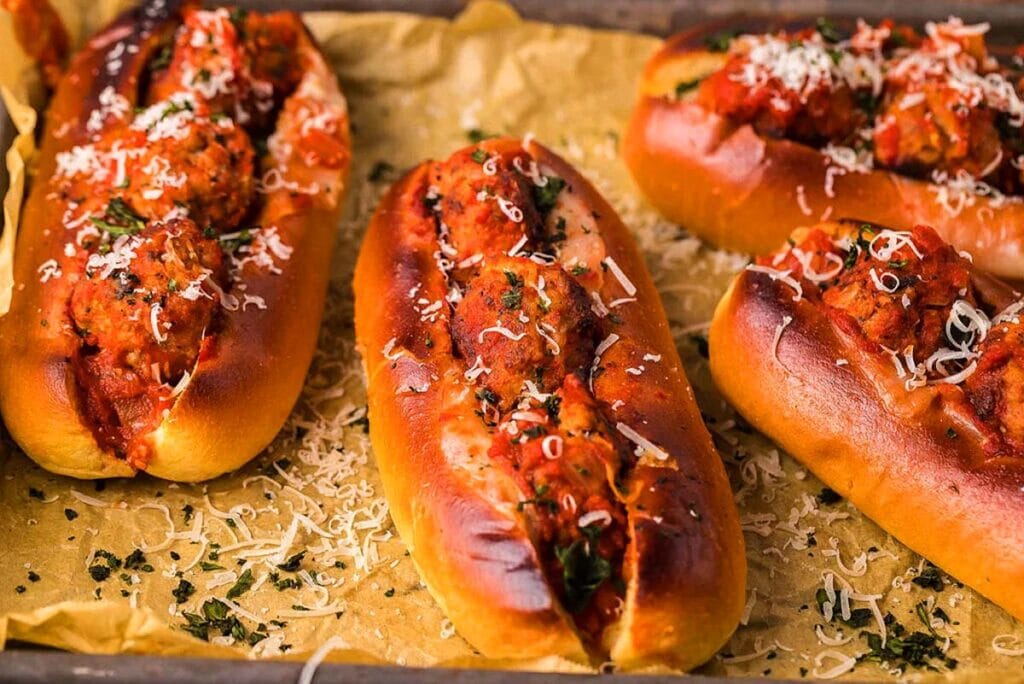 Meatball subs are in toasted buns on a tray. The Best easy dinner recipes.