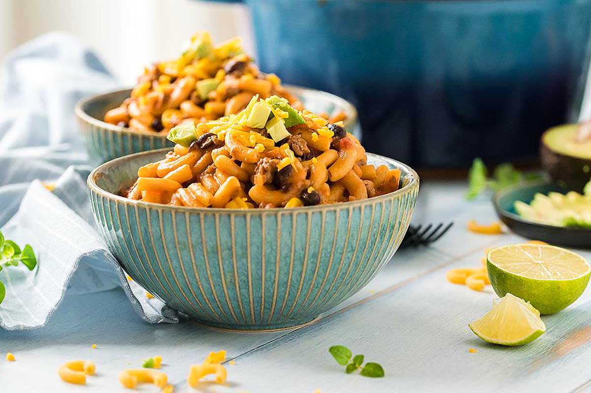cheesy taco pasta in a blue bowl.