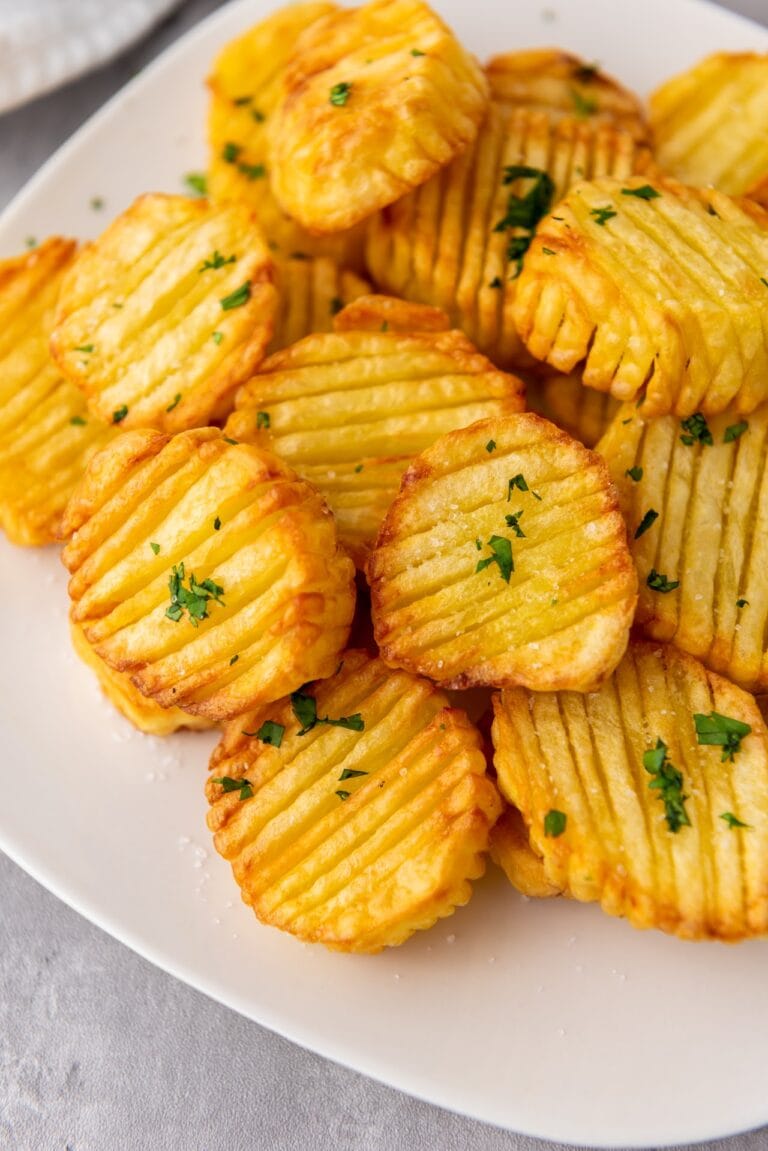 accordian potatoes on a white plave