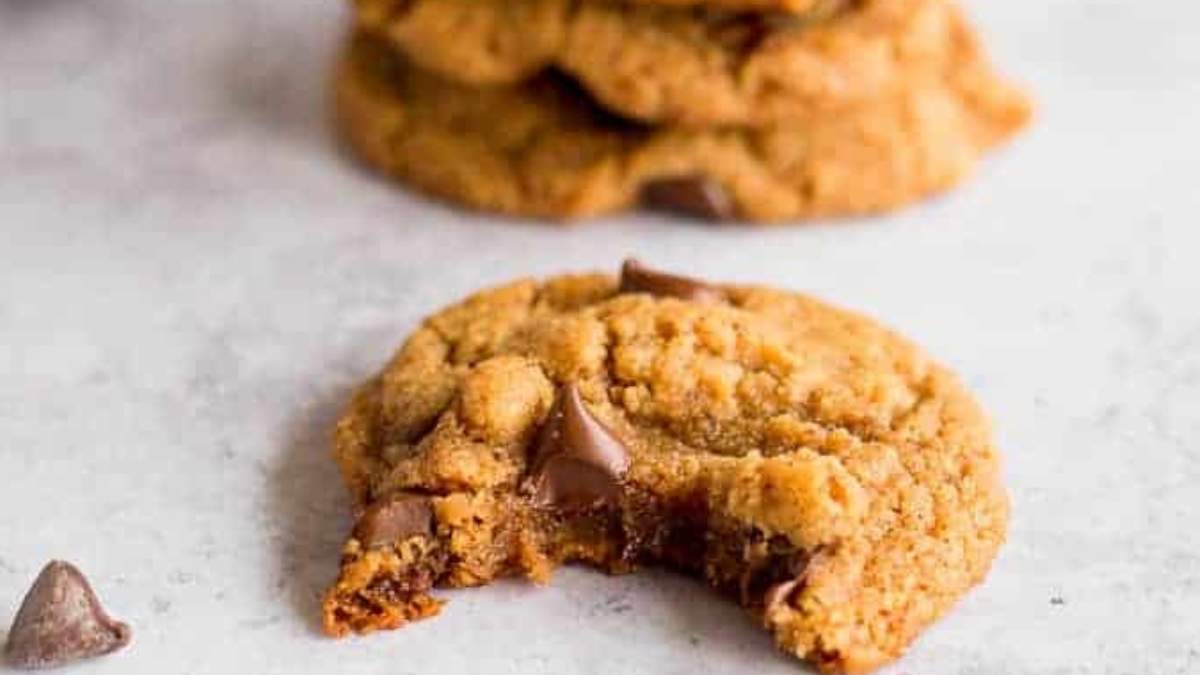 A delicious cookie with a bite taken out of it.