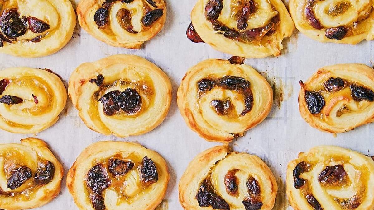 A roundup of shared cookie recipes featuring a tray of raisin and raisin pastries on a baking sheet.