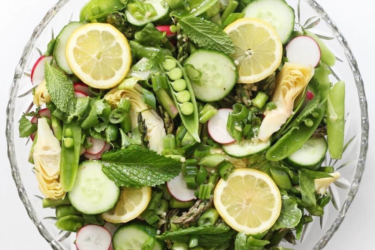A salad with cucumbers, radishes and lemons.