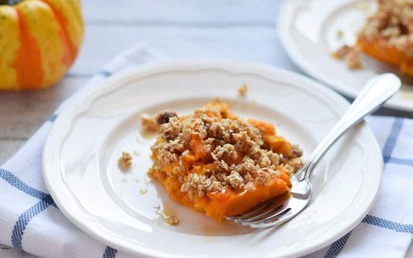 Sweet potato casserole slice on a white plate.