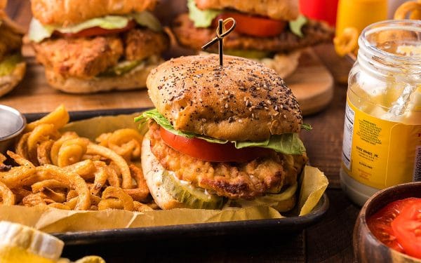Fried chicken sandwich with french fries on the side.
