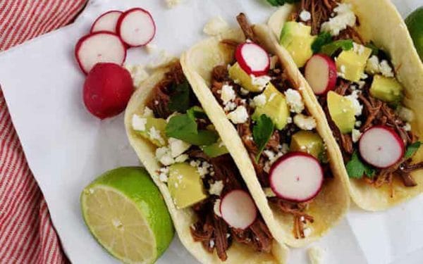Two ingredient beef tacos with toppings.