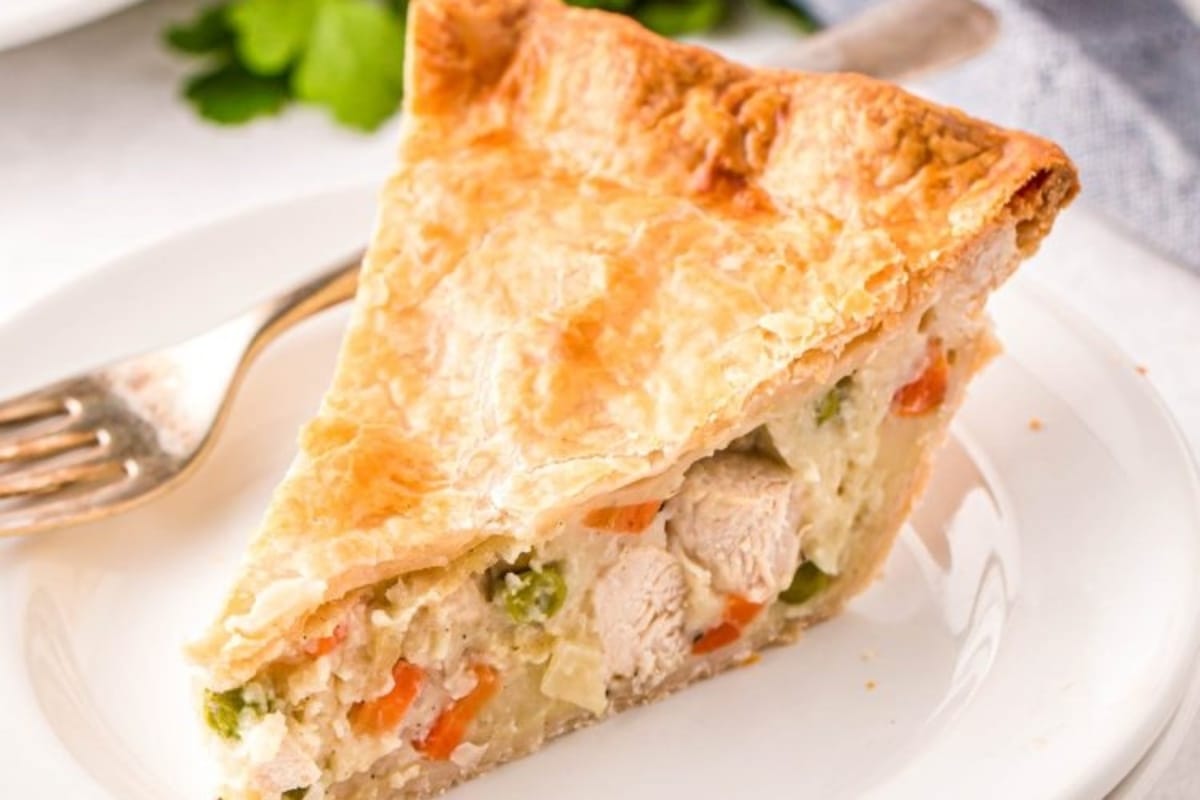 A slice of chicken pot pie on a white plate.
