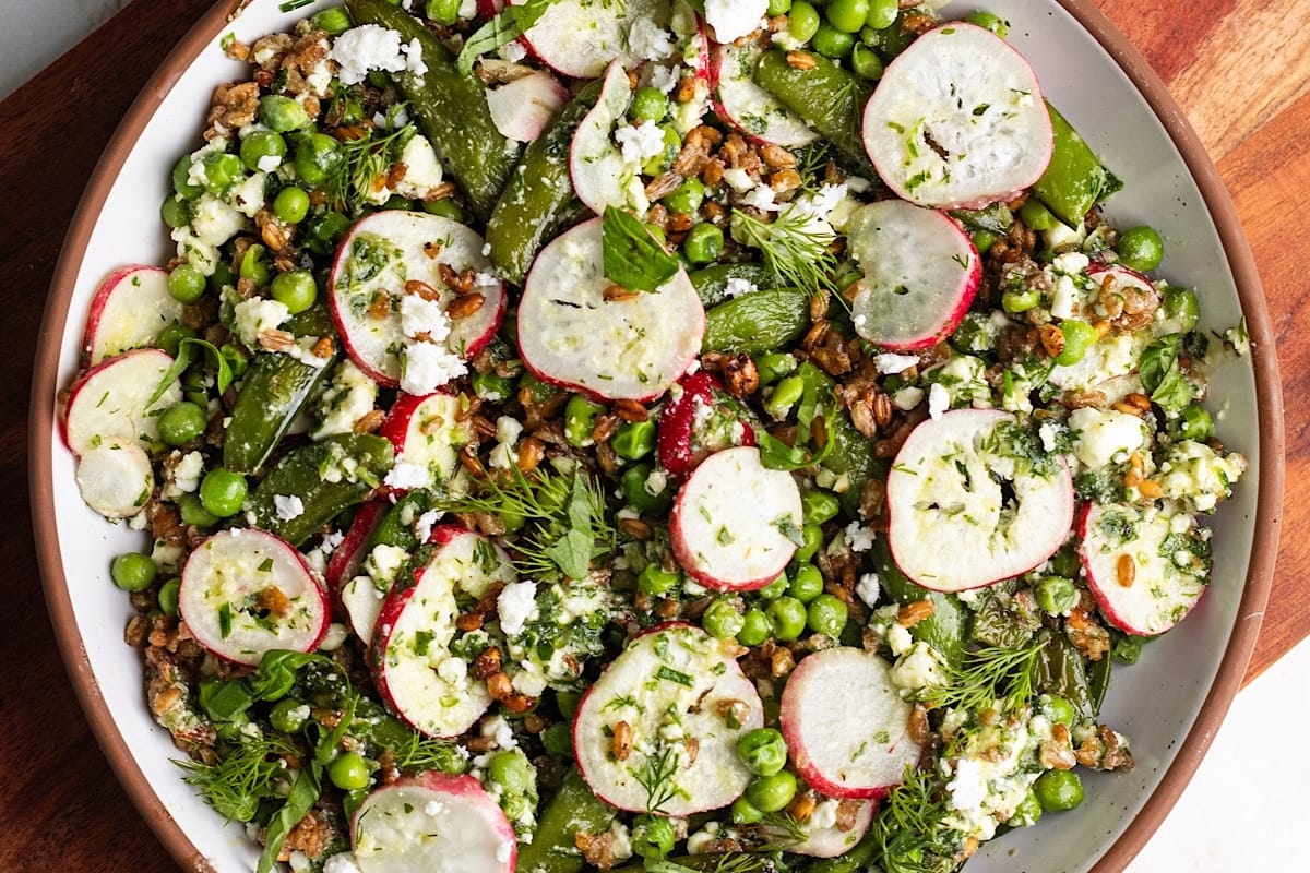 A plate with radishes, peas and lentils.