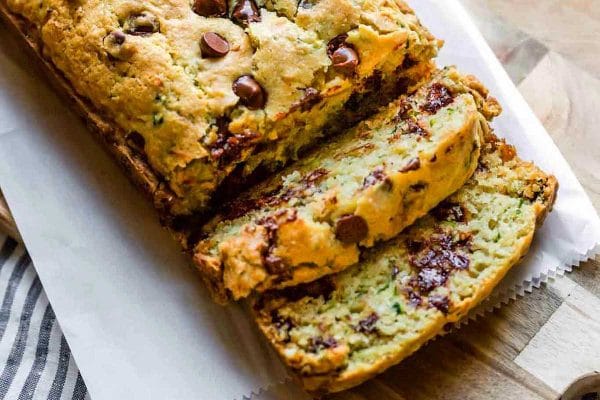 A slice of zucchini bread on a cutting board.