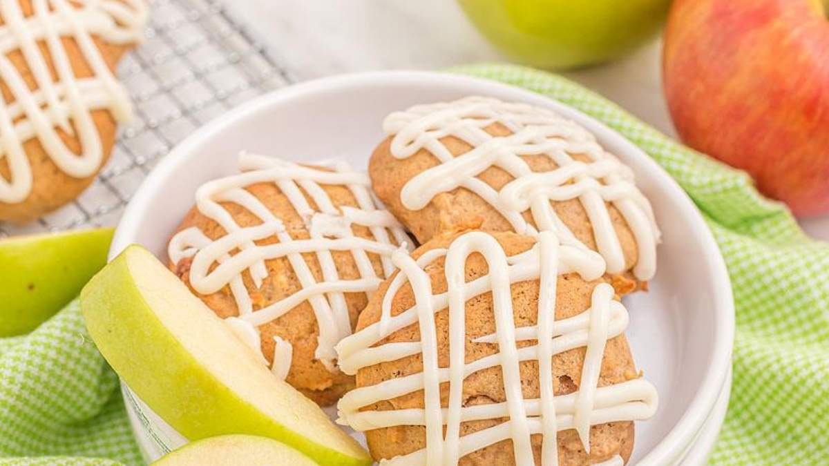 SHARED Apple cookies with icing and apples on a plate for some delightful ROUNDUP of Cookie Recipes.