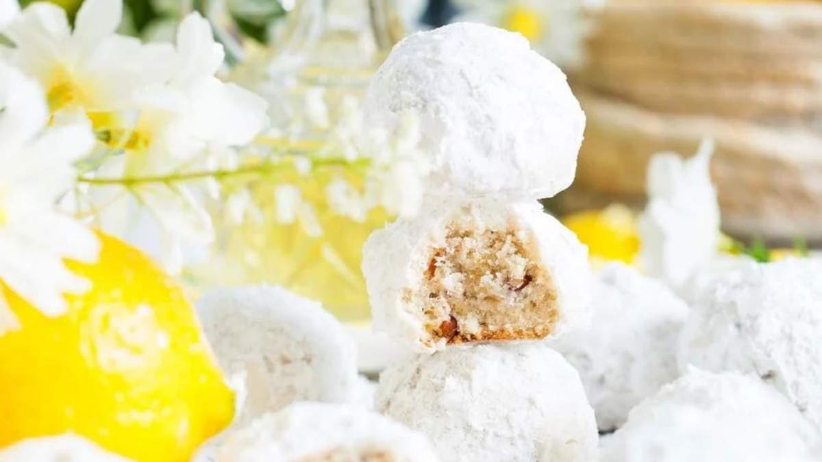 A shared stack of lemon sugar cookies on a table.