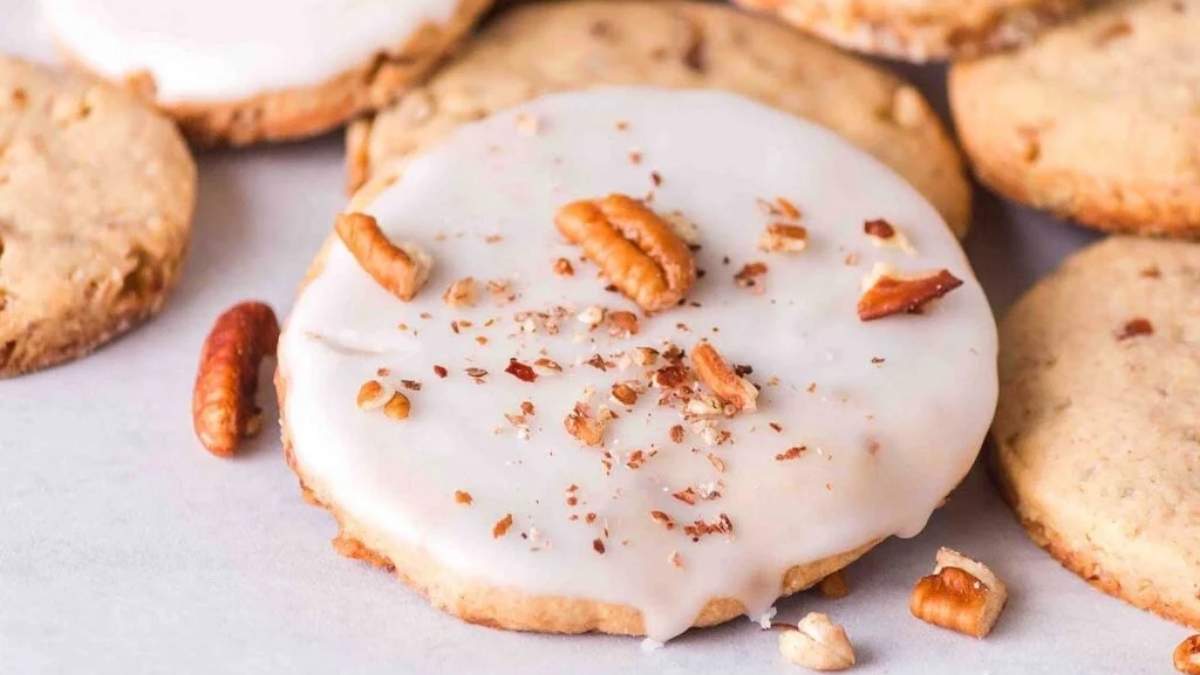 A SHARED plate of ROUNDUP cookies with icing and pecans.