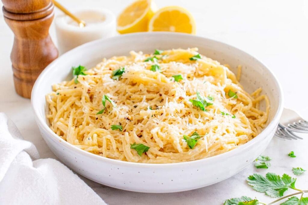 Creamy lemon pasta in a large white bowl.