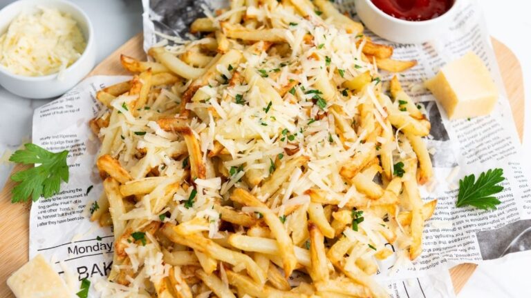 Fries with cheese on top with dips on the side.