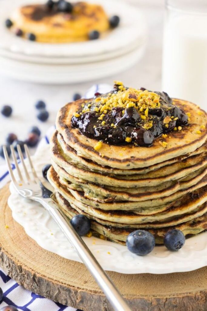 Stack of pancakes with blueberries on top.