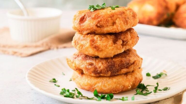 Stack of potato fritters on a plate.