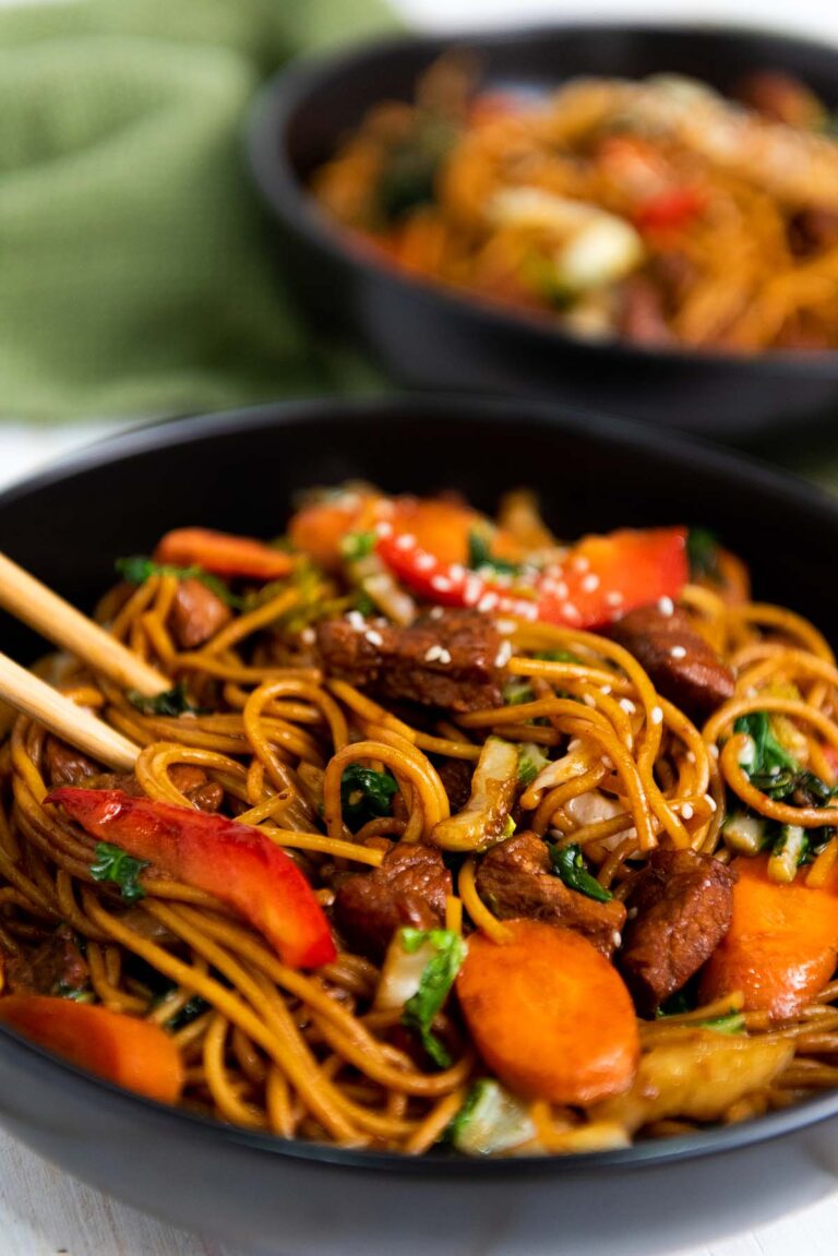 Lo mein in a bowl with chopsticks.