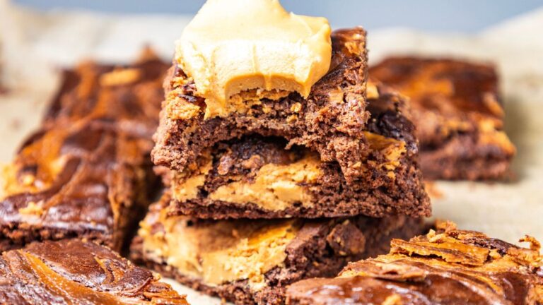 Stack of peanut butter brownies with bite.