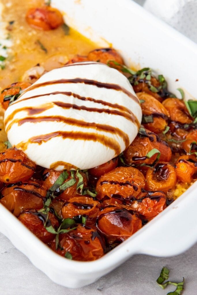 Cherry tomatoes with burrata on top.