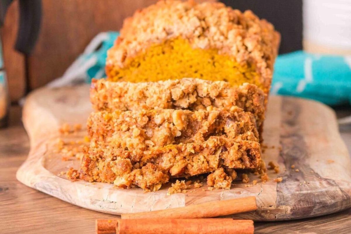 Pumpkin Crunch Bread with three slices on a cutting board. 