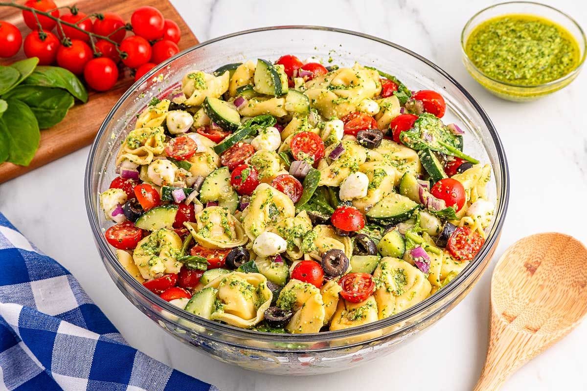 Pesto tortellini pasta salad in a glass dish.